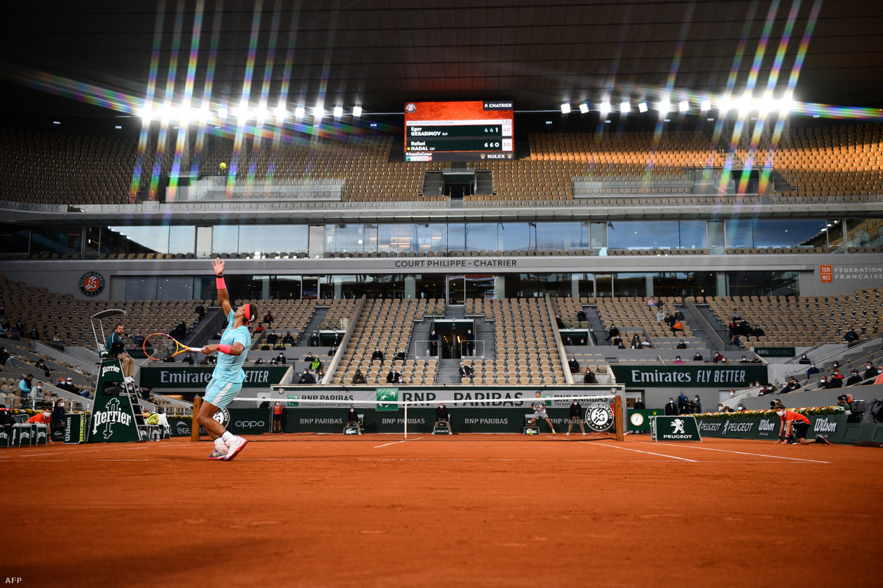 Rafael Nadal serves on Roland Garros at Philippe Chatrier Stadium.  He plays the Spanish tennis player 