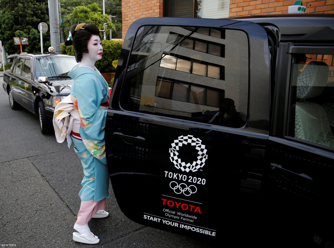 Koyku Geisha sits in a taxi to go to work in Tokyo, June 23, 2020