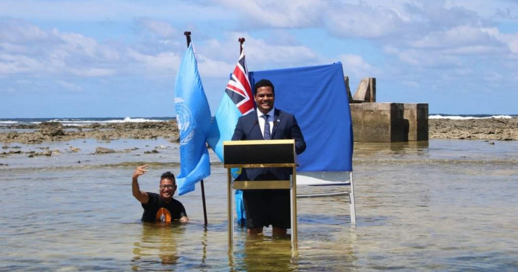 INDEX - OUTSIDE - Standing in the water, Tuvalu's foreign minister delivers a message to the Climate Summit