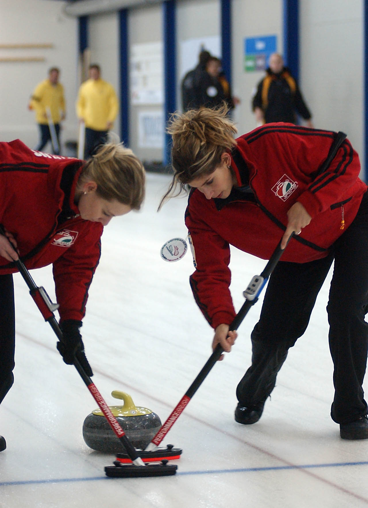 Alexandra Pires and Kristina Bartalos (M), members of the Hungarian national team, sweep on the ice.  MTI Photo: Tamás Kovács