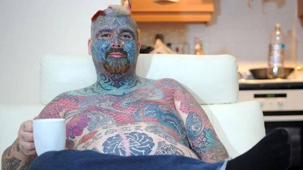 He's the most tattooed man in Britain, but he's embarrassed at work